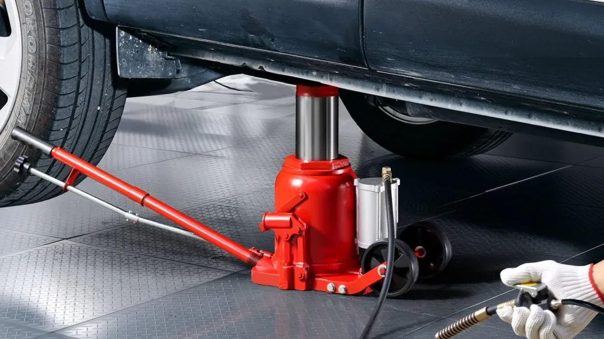 Air hydraulic bottle jack lifting a car