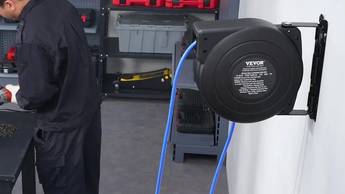 VEVOR 50 ft retractable extension cord reel powering tools at a workbench
