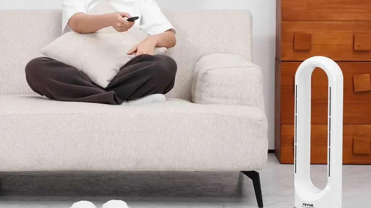 Bladeless tower fan beside a sofa in a living room