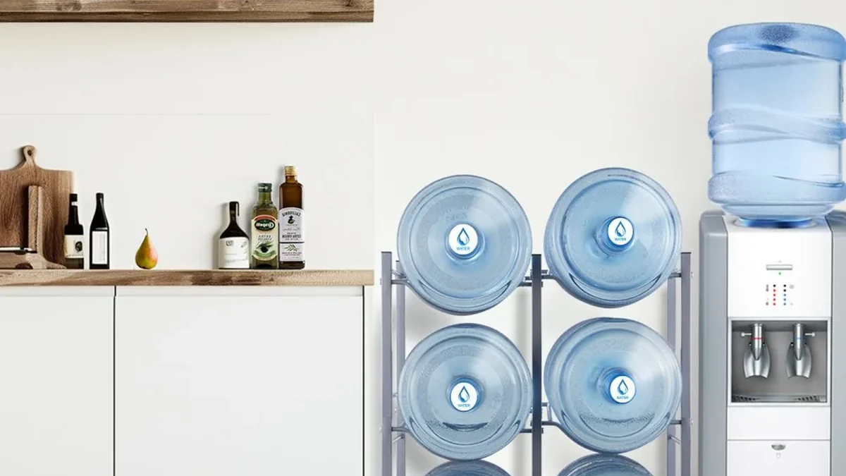 Water bottle rack beside a water dispenser in a kitchen